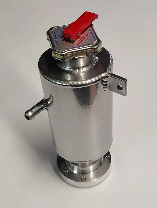 Metal container with a red valve on a white surface