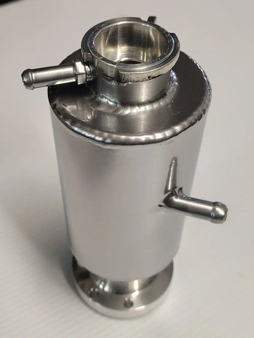 Metallic container with two valves on a white surface