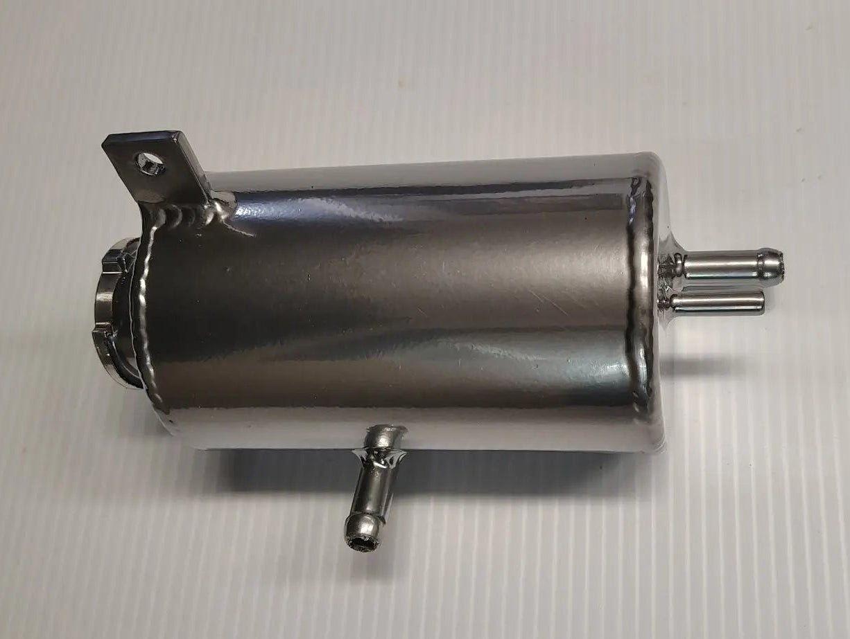 Metallic cylindrical component on a gray background